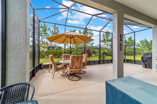 view of patio with grilling area and glass enclosure