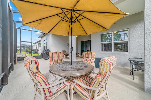 view of patio featuring a lanai