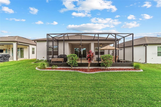 rear view of property with glass enclosure and a yard