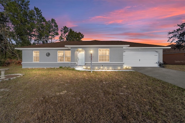 single story home with a yard and a garage