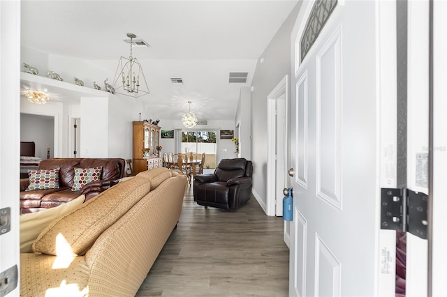 living room featuring light hardwood / wood-style flooring and a notable chandelier