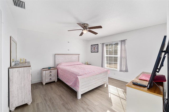 bedroom with hardwood / wood-style floors and ceiling fan