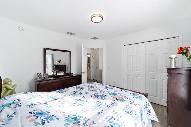 bedroom featuring hardwood / wood-style flooring and a closet