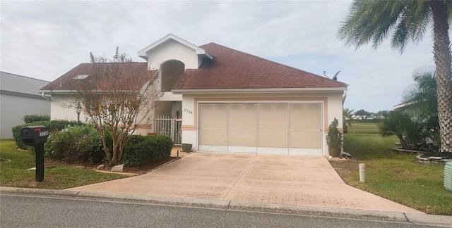 view of front of house featuring a front lawn and a garage