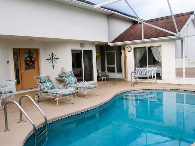 view of pool featuring a patio area and glass enclosure