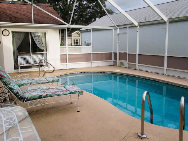 view of pool featuring a patio area and glass enclosure