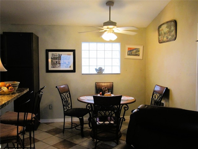 dining room with tile patterned flooring and ceiling fan