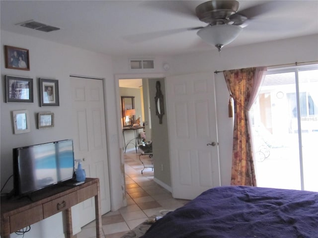 tiled bedroom with ceiling fan