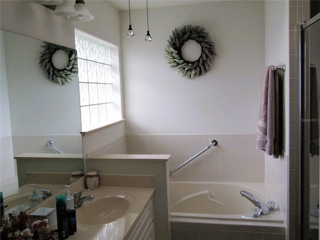 bathroom featuring vanity and plus walk in shower