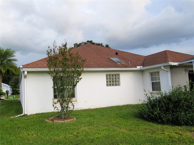 view of property exterior with a yard