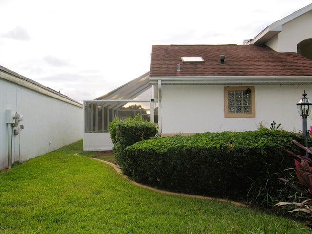 view of side of property with a lawn