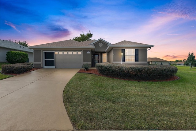 view of front of property with a lawn and a garage