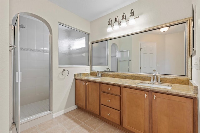 bathroom with vanity, a shower with shower door, and tile patterned floors