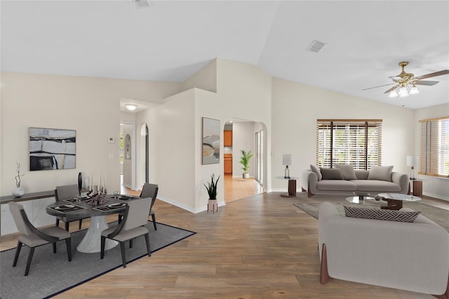 dining area with wood-type flooring, ceiling fan, and vaulted ceiling