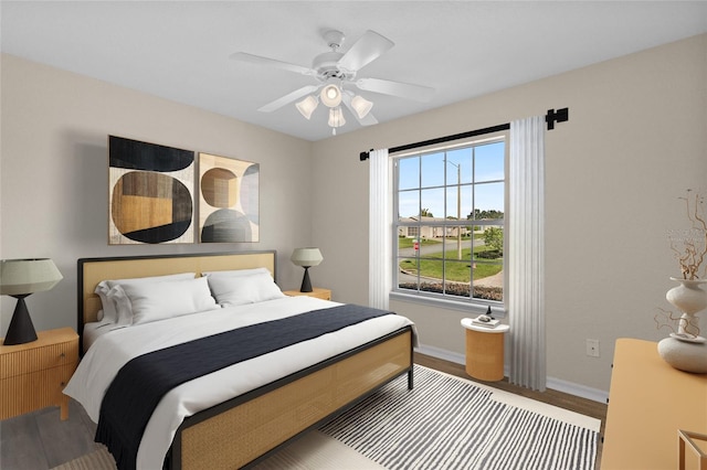 bedroom with hardwood / wood-style flooring and ceiling fan