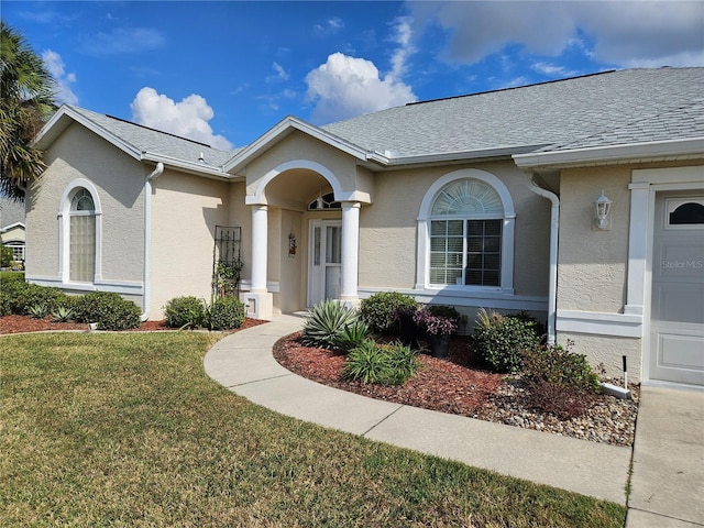 view of front of home with a front yard and a garage