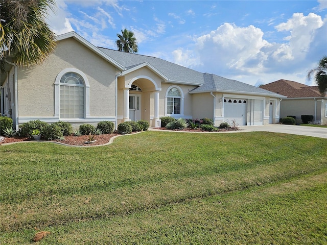 ranch-style home featuring a front lawn and a garage