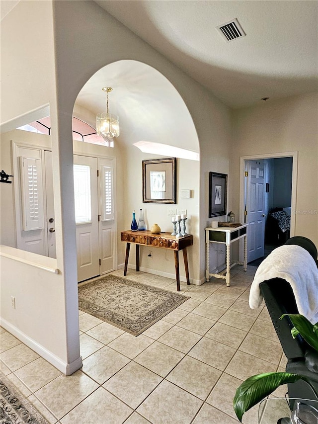 foyer featuring a notable chandelier and light tile patterned floors