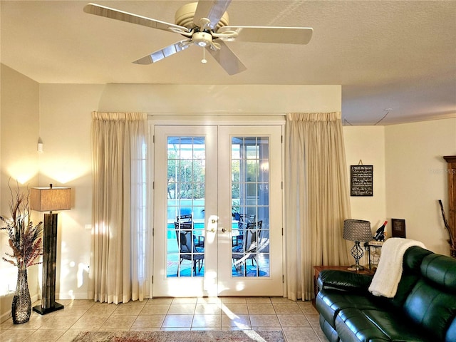 doorway to outside featuring french doors, light tile patterned flooring, a textured ceiling, and ceiling fan