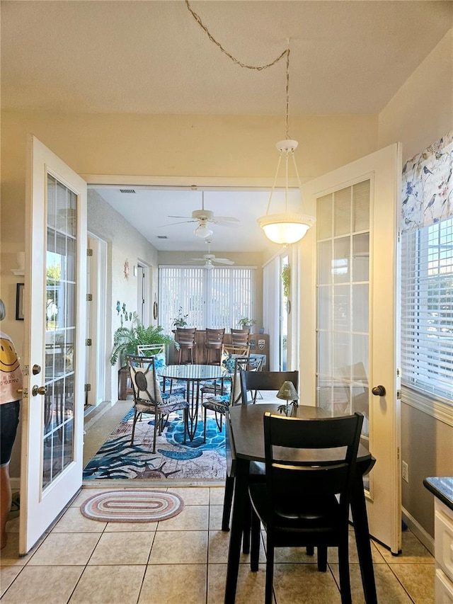 dining room with french doors, ceiling fan, and light tile patterned floors