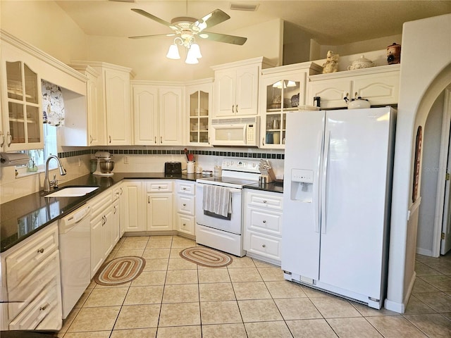 kitchen with white appliances, tasteful backsplash, sink, and white cabinets