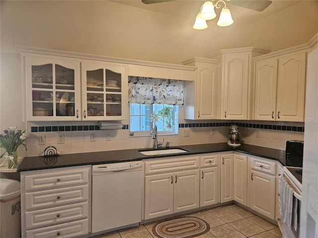 kitchen with dishwasher, white cabinets, sink, and tasteful backsplash