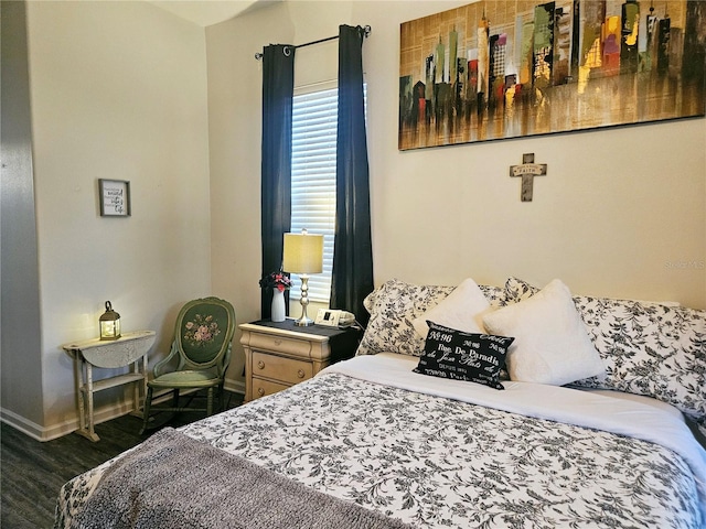 bedroom with dark hardwood / wood-style floors