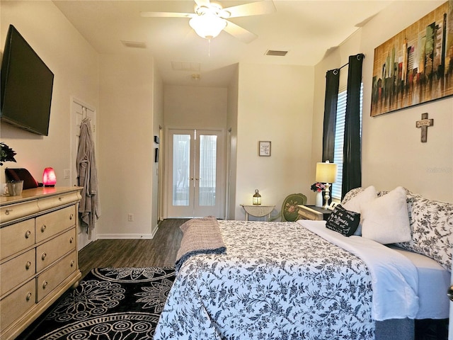 bedroom featuring dark wood-type flooring, ceiling fan, french doors, and multiple windows