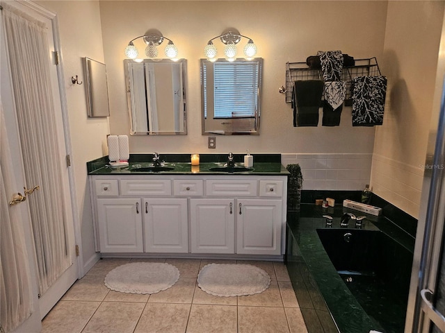 bathroom featuring vanity, a tub, and tile patterned flooring