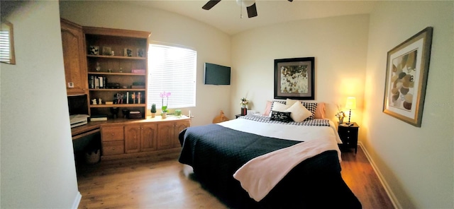 bedroom featuring hardwood / wood-style flooring, vaulted ceiling, and ceiling fan