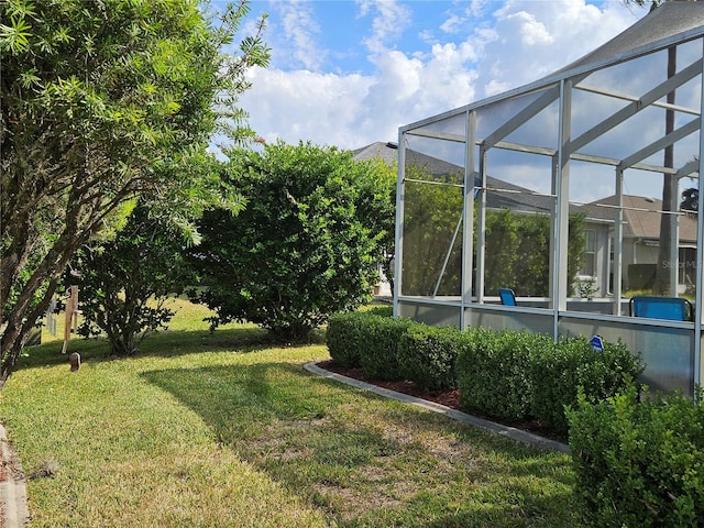 view of yard featuring glass enclosure