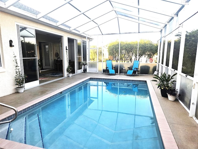 view of swimming pool with a patio and glass enclosure