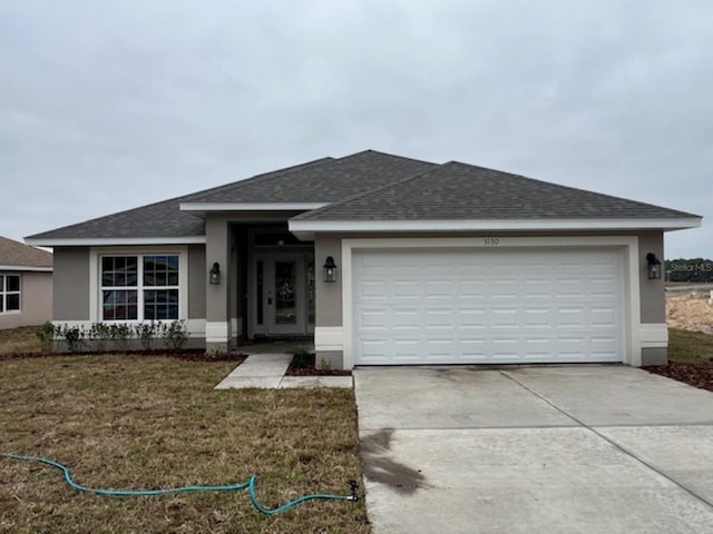 view of front facade with a garage and a front yard