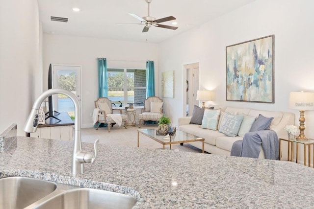 living room featuring sink and ceiling fan