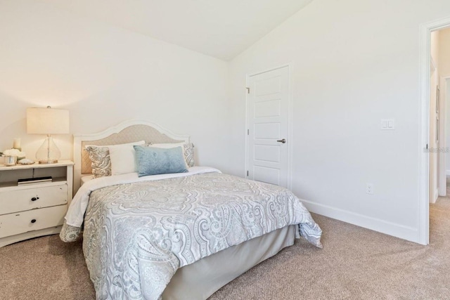 carpeted bedroom with vaulted ceiling