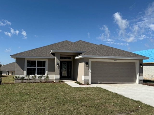 view of front of property with a front lawn and a garage