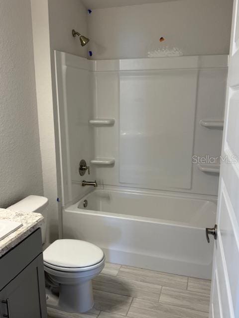 full bathroom featuring toilet, vanity, and shower / washtub combination