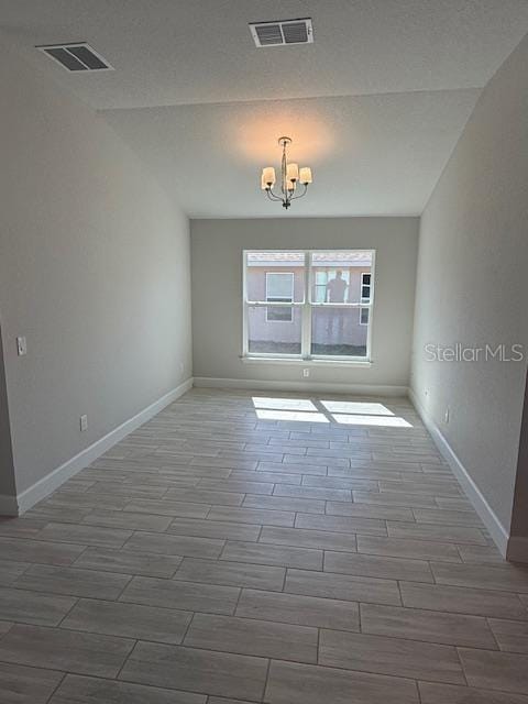 empty room with an inviting chandelier