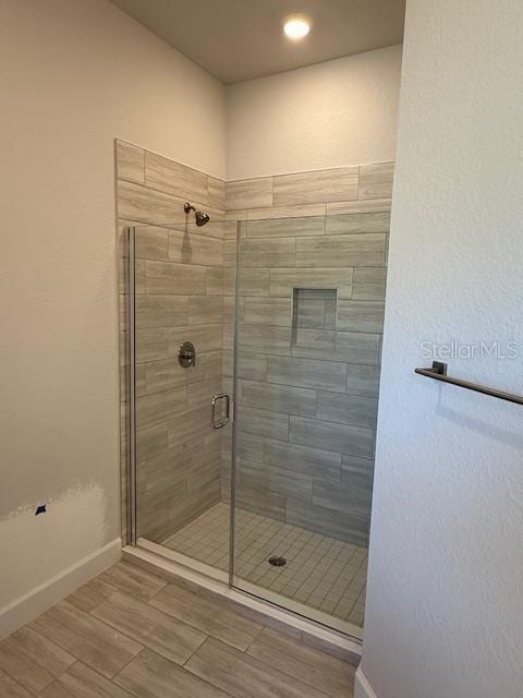 bathroom with a shower with shower door