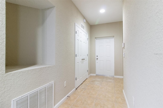 corridor with light tile patterned floors