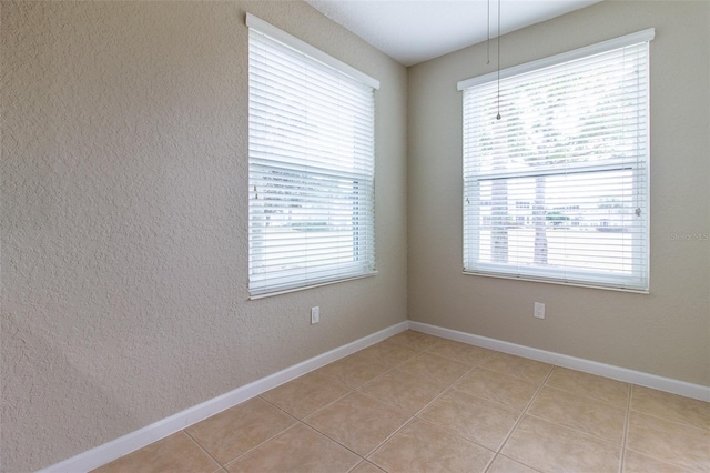 tiled empty room with plenty of natural light