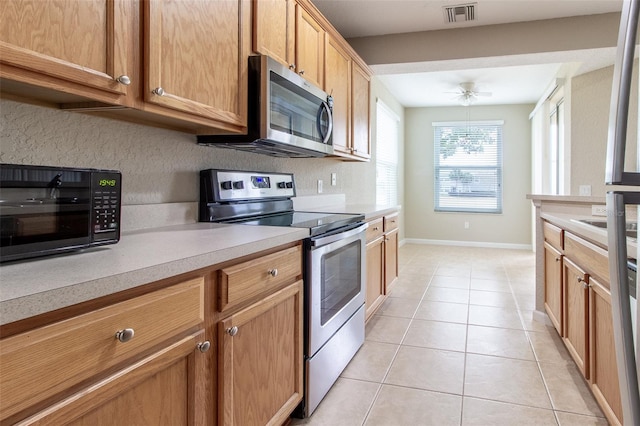 kitchen with ceiling fan, light tile patterned floors, sink, and appliances with stainless steel finishes