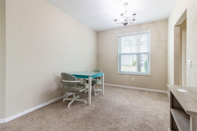 dining area featuring carpet, a textured ceiling, and an inviting chandelier