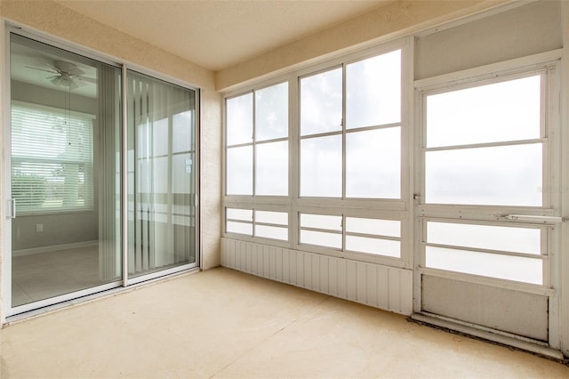 unfurnished sunroom featuring plenty of natural light and ceiling fan