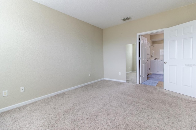 unfurnished room with light carpet