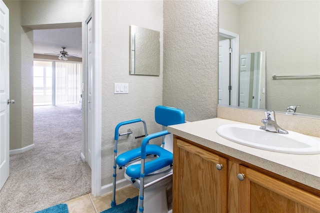 bathroom featuring ceiling fan, tile patterned flooring, vanity, and toilet