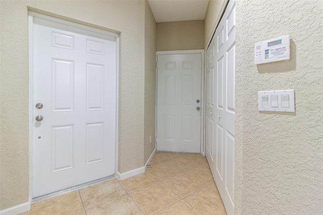 hall featuring light tile patterned flooring