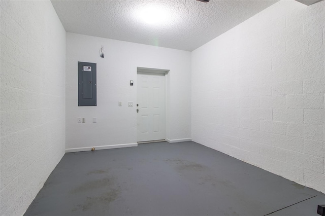 empty room with a textured ceiling and electric panel