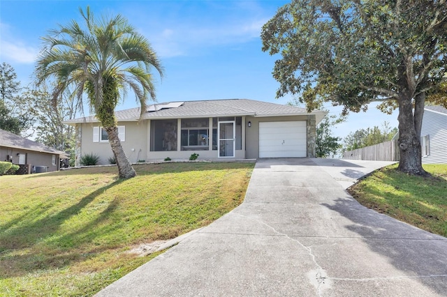 single story home featuring a front yard and a garage