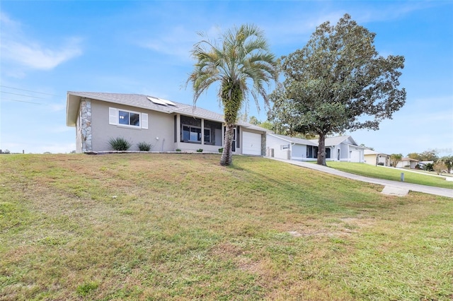 single story home featuring solar panels, a front lawn, and a garage